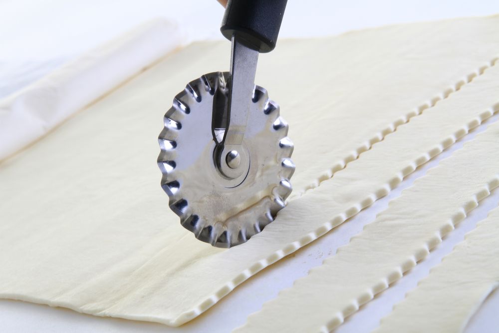 Dough cutter serrated blade